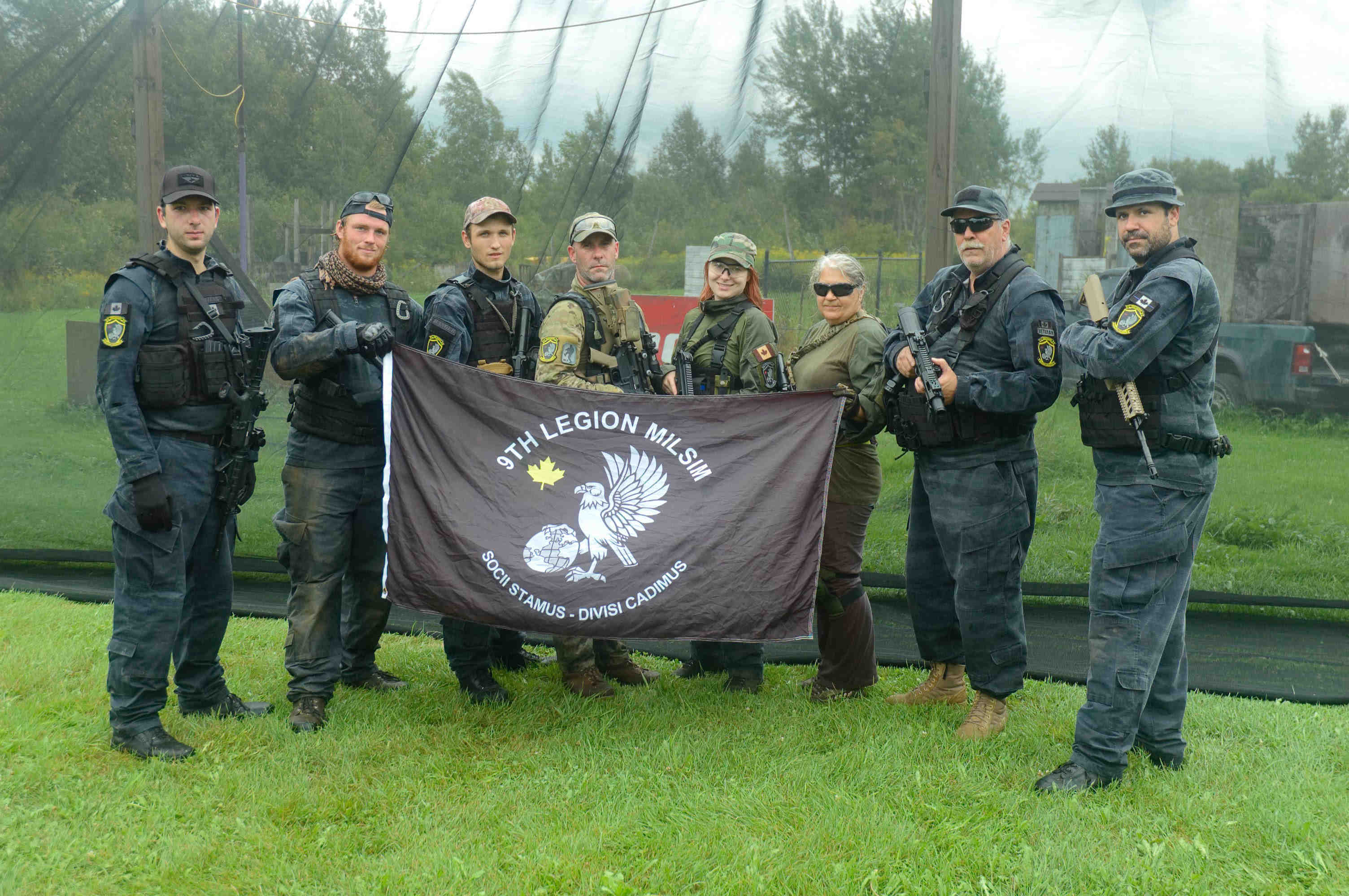 Photo of the team holding the team flag